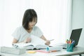 Asian lady student read a text book for prepare to examination. Person, office. Royalty Free Stock Photo