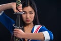 Asian lady with sword in studio Royalty Free Stock Photo