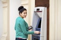 Asian lady using an automated teller machine Royalty Free Stock Photo