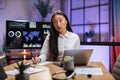 Asian lady using laptop and taking notes at office Royalty Free Stock Photo