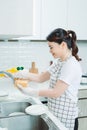 Asian lady wash a dish in kitchen room Royalty Free Stock Photo