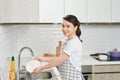 Asian lady wash a dish in kitchen room Royalty Free Stock Photo