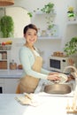 Asian lady wash a dish in kitchen room Royalty Free Stock Photo