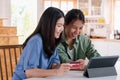 Asian lesbain couple using tablet and credit card to shopping online on kitchen table in home.couple lgbtq lifestyle concept Royalty Free Stock Photo