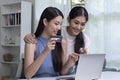 Asian lesbian couple holding credit card and using laptop computer. LGBT lesbian businesswoman working at home. Online shopping Royalty Free Stock Photo
