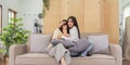 Asian lesbian woman couple enjoy watch TV together in house and feel scared watch movie on television. Homosexual-LGBTQ