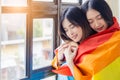Asian LGBT couple or lesbian couple Happy young asia homosexual women stand near window Romantic girls smiling with friendship