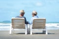 Asian Lifestyle senior couple sitting on the chair beach.  People old happy in love romantic and relax time on the sand beach. Royalty Free Stock Photo