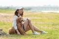 Asian lifestyle woman playing  with golden retriever friendship dog so happy and relax near the road Royalty Free Stock Photo