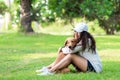 Asian lifestyle woman playing and hug young golden retriever friendship dog in outdoor Royalty Free Stock Photo