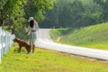 Asian lifestyle woman walking so happy with golden retriever friendship dog near the road Royalty Free Stock Photo