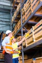 Asian lift truck driver and foreman in storage Royalty Free Stock Photo