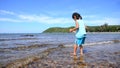 Asian littel girl with nature sea and blue sky waves towards the coast of Sattahip Chonburi Thailand