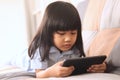 Asian little baby girl plays with gadget smart phone, children with phone addict