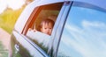 Asian little baby girl traveling looking out from windows car Royalty Free Stock Photo