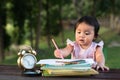 Asian little baby toddler drawing at park with copy space Royalty Free Stock Photo