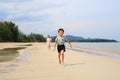 Asian little boy child and girl kid having fun running on tropical sand beach at sunrise. Happy family sister and brother enjoy in Royalty Free Stock Photo