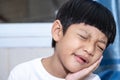 Asian little boy is doing a terrible toothache. Portrait a little boy suffering from toothache. Oral Care Concepts