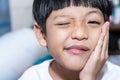 Asian little boy is doing a terrible toothache. Portrait a little boy suffering from toothache. Oral Care Concepts