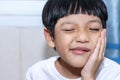 Asian little boy is doing a terrible toothache. Portrait a little boy suffering from toothache. Oral Care Concepts Royalty Free Stock Photo