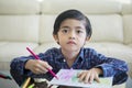 Asian little boy drawing with color pencils at home Royalty Free Stock Photo