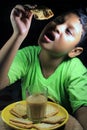 Poco niño comer galleta vidrio de té 