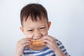 Asian boy eating bread before go to school Royalty Free Stock Photo