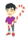 Asian little boy holding christmas candy cane. Royalty Free Stock Photo