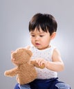 Asian little boy holding toy doll Royalty Free Stock Photo