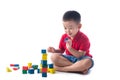 Asian little boy playing with colorful blocks, isolated on white Royalty Free Stock Photo