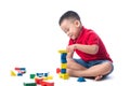 Asian little boy playing with colorful blocks, isolated on white Royalty Free Stock Photo