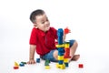 Asian little boy playing with colorful blocks, isolated on white Royalty Free Stock Photo