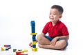 Asian little boy playing with colorful blocks, isolated on white Royalty Free Stock Photo