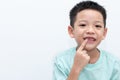 Asian little boy was pointing at his permanent teeth are growing. A 5-year-old boy whose upper milk tooth incisor fell out. Kid Royalty Free Stock Photo