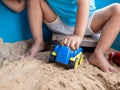 Asian little child boy hand playing car toy and sand in sandbox Royalty Free Stock Photo
