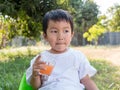 Asian little child boy holding glass of orange juice with smiling Royalty Free Stock Photo