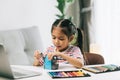 asian little child girl drawing with color pencils in living room at home Royalty Free Stock Photo