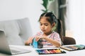 asian little child girl drawing with color pencils in living room at home Royalty Free Stock Photo