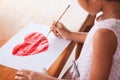 Asian little child girl drawing and painted a heart Royalty Free Stock Photo