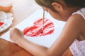 Asian little child girl drawing and painted a heart Royalty Free Stock Photo