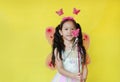 Asian little child girl dressed in fairy costume isolated on yellow Royalty Free Stock Photo