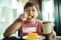 Asian little child girl eating chiffon cake Royalty Free Stock Photo