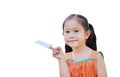 Asian little child girl fold a piece of white paper to rocket and showing on her forefinger isolated on white background.