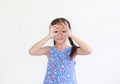 Asian little child girl with hands glasses in front of her eyes isolated on white background. Kid looking through imaginary Royalty Free Stock Photo