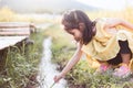 Asian little child girl having fun to play with water stream Royalty Free Stock Photo