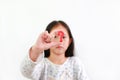 Asian little child girl holding red question mark sign over white background. Selective focus Royalty Free Stock Photo