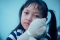 Asian little child girl hugging teddy bear with lonely and sadness Royalty Free Stock Photo