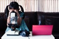 Asian little child girl looking microscope and learning online by using laptop and at home , distance education
