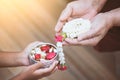 Asian little child girl pouring water on hands of elder senior Royalty Free Stock Photo