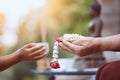 Asian little child girl pouring water on hands of elder senior Royalty Free Stock Photo